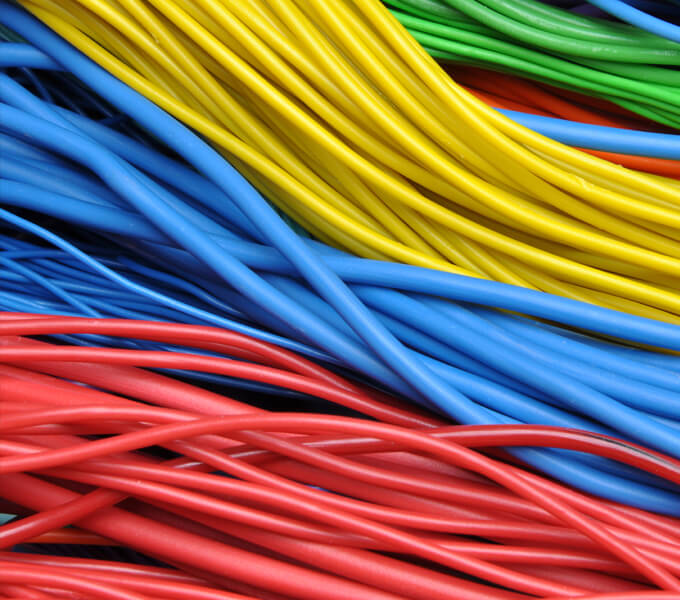 Several colourful cables are shown next to each other in the colours red, blue, yellow and green.